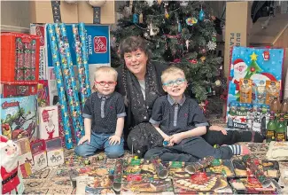  ??  ?? Aimee with younger sons Bertie, left, and Dexter and some of their festive goodies