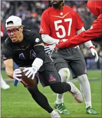  ?? DAVID BECKER — THE ASSOCIATED PRESS ?? NFC receiver Amon-Ra St. Brown, left, of the Detroit Lions scores a touchdown during the flag football event at the NFL Pro Bowl, Sunday in Las Vegas. The score helped the NFC to a 35-33 win.