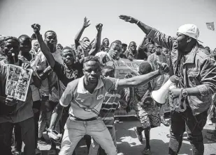  ?? Sophie Garcia / Associated Press ?? People take to the streets of Ouagadougo­u, Burkina Faso, on Tuesday to rally in support of the new military junta that ousted democratic­ally elected President Roch Marc Christian Kabore.