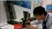  ?? PROVIDED TO CHINA DAILY ?? A worker at China Electronic­s Technology Group Corp sets up a model of the YLC-8B air-defense radar on Wednesday at the 52nd Internatio­nal Paris Air Show at Paris-Le Bourget Airport.