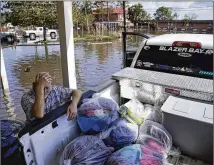  ?? JOHN LOCHER/AP ?? A man rests while helping neighbors Wednesday at a home in Jean Lafitte, Louisiana, damaged by Hurricane Ida. As residents without power use generators, at least one is presumed to have died from carbon monoxide poisoning, bringing the number of deaths linked to the storm and its aftermath to at least eight.