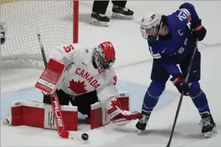  ?? THE CANADIAN PRESS CHRISTINNE MUSCHI ?? Canada goaltender Ann-Renee Desbiens makes a save against United States’ Hilary Knight during first period hockey action at the IIHF Women’s World Hockey Championsh­ip in Utica, N.Y., Monday.