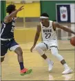  ?? ROB SIMMONS — CSM — SIENA COLLEGE VIA AP ?? Siena point guard Jalen Pickett, right, controls the ball against a Monmouth player during a game on Sunday. Siena finally began its season on Sunday, 298 days after its last game.