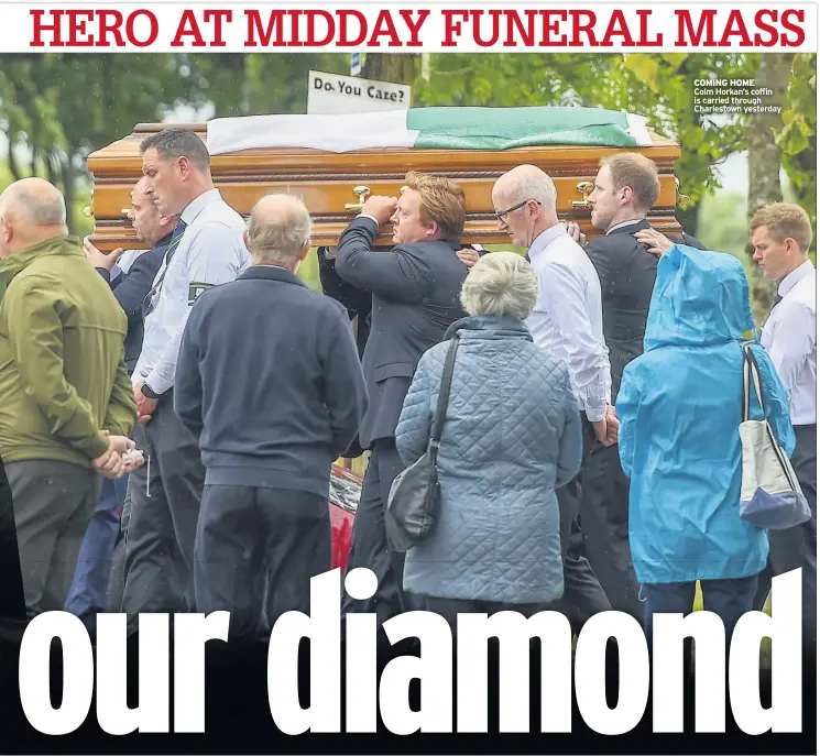  ??  ?? COMING HOME
Colm Horkan’s coffin is carried through Charlestow­n yesterday