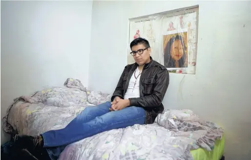  ?? THE ASSOCIATED PRESS ?? Student Dario Guerrero sits in his bedroom at his grandparen­ts’ home in Mexico in front his late mother’s portrait.