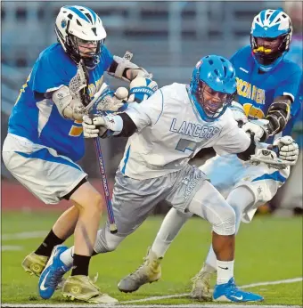  ?? TIM MARTIN/THE DAY ?? Waterford’s Luther Wade, center, is checked by Bacon Academy’s Noah Mocksfield, left, with Julian Lindo moving in from behind during Tuesday night’s Eastern Connecticu­t Conference boys’ lacrosse tournament semifinal at Montville High School. The...