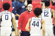  ?? David Butler II / Associated Press ?? UConn coach Dan Hurley greets his players during a break against Georgetown in the first half on Saturday.