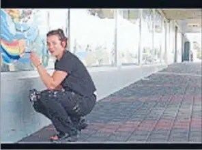  ??  ?? ON THE WALL: Wendy Arnold outside Van Dyks where she painted a 50-metre long mural.