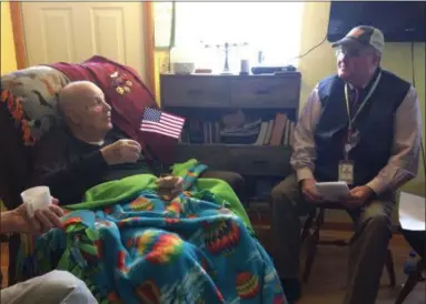  ?? CHAD FELTON — THE NEWS-HERALD ?? World War II veteran John Esborn, left, 98, speaks with Crossroads Hospice Chaplain Charles Pahlman during a Gift of Honor recognitio­n ceremony held on Dec. 7. Pahlman and about a dozen others gathered in Esborn’s home in Wickliffe to honor his service and sacrifice.