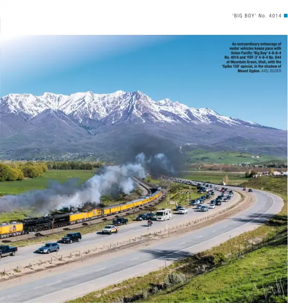  ?? AXEL BOZIER ?? An extraordin­ary entourage of motor vehicles keeps pace with Union Pacific ‘Big Boy’ 4-8-8-4 No. 4014 and ‘FEF-3’ 4-8-4 No. 844 at Mountain Green, Utah, with the ‘Spike 150’ special, in the shadow of Mount Ogden.