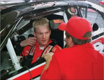  ?? CHUCK BURTON — THE ASSOCIATED PRESS ?? Dale Earnhardt Jr. listens to a crew member as he sits in his Winston Cup race car before a practice session in 1999 at Lowe’s Motor Speedway in Concord, N.C. Earnhardt retired after Sunday’s race, having never won a championsh­ip. He never filled his...