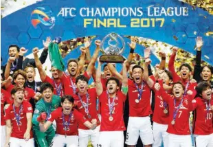  ??  ?? Urawa Red Diamonds’ players celebrate on the podium after lifting the 2017 AFC Champions League trophy.