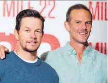  ?? VALERIE MACON/GETTY IMAGES ?? “It’s like a brotherhoo­d,” director Peter Berg, right, says of his working relationsh­ip with Mark Wahlberg.