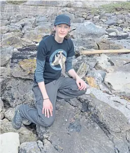  ?? Picture: PA ?? Dr Elsa Panciroli with a dinosaur bone which has been found on the Isle of Eigg.