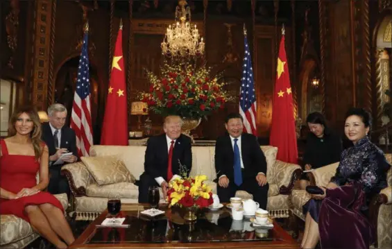 ?? ALEX BRANDON — THE ASSOCIATED PRESS ?? President Donald Trump and Chinese President Xi Jinping, with their wives, first lady Melania Trump, left, and Chinese first lady Peng Liyuan, right, pose for photograph­ers before dinner at Mar-a-Lago, Thursday in Palm Beach, Fla.