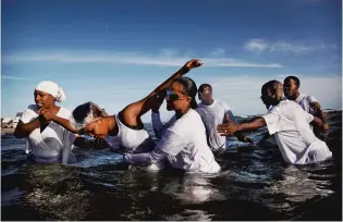  ?? COURTESY OF THE CHRYSLER MUSEUM OF ART ?? “Together in Celebratio­n” will exhibit times of ease and play, such as sports and dancing. Art pieces, including this image “Baptism” by Pulitzer-prize winning photograph­er Preston Gannaway, will be on display.