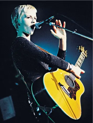  ??  ?? One of a kind: Dolores O’riordan with the Cranberrie­s in 1994. Below: band members Mike Hogan, Noel Hogan and Fergal Lawler