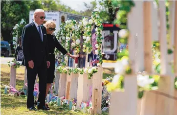  ?? EVAN VUCCI/ASSOCIATED PRESS ?? President Joe Biden and first lady Jill Biden visit a memorial at Robb Elementary School on Sunday to pay their respects to the victims of the mass shooting in Uvalde, Texas. The visit was the president’s second trip in as many weeks to console a community mourning a staggering loss after a shooting.