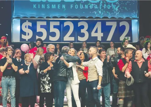  ?? BRANDON HARDER ?? With the amount raised in the background, participan­ts celebrate Sunday’s successful Kinsmen Telemiracl­e telethon fundraiser on stage at the Conexus Arts Centre.