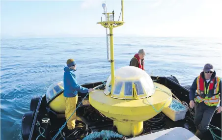  ??  ?? A University of Victoria-based team deploys a buoy and precision instrument­s to measure waves off Ucluelet.