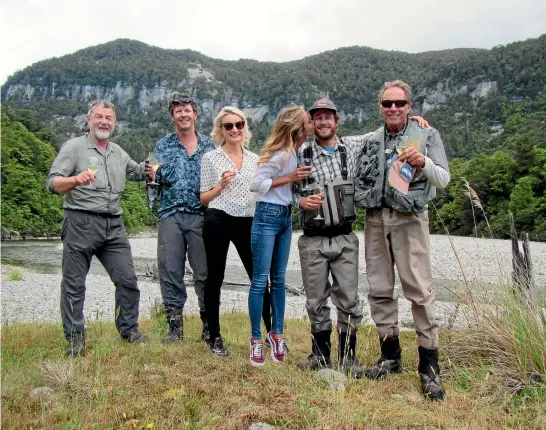  ??  ?? The happy couple, Corey Ratner and Jordan, centre, on the banks of the Karamea River. Fishing guides Tony Entwistle, left, and Zane Mirfin, second from left, and friends Dacha, and Dale Kinsella celebrate the engagement.