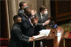  ?? Hans Pennink/Associated Press ?? Members of the state Senate applaud after Sen. Liz Krueger, D-New York, sponsored legislatio­n to legalize adult-use cannabis, which passed in the Senate during a Legislativ­e Session on Tuesday at the state Capitol in Albany, N.Y.