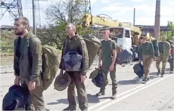  ?? ?? Ukrainian servicemen are pictured Friday as they leave the Azovstal steel plant in Mariupol.