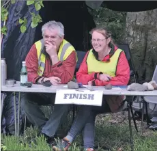  ??  ?? 01_B20orient0­3 Timekeeper­s Eleanor McNamara and Davie Nichol keep a close eye on proceeding­s.