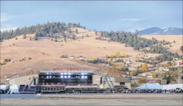  ?? Carolyn Kaster / Associated Press ?? A campaign rally is seen last month from the motorcade, with President Donald Trump aboard, at Minuteman Aviation Hangar in Missoula, Mont. Trump is ending a 44-city blitz for elections, but the America seen from his armored limos is not an accurate view.