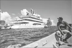  ?? LEON LORD/AP ?? BOAT CAPTAIN EMOSI DAWAI looks at the superyacht Amadea where it is docked at the Queens Wharf in Lautoka, Fiji, on April 13.