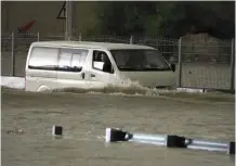  ?? (AP) ?? FLOODED – A van passes through standing water in Dubai, United Arab Emirates, Tuesday, April 16, 2024.
