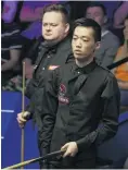  ?? PHOTO: AP ?? Cruising for a bruising . . . China’s Luo Honghao prepares to play as England’s Shaun Murphy looks on during day three of the Snooker World Championsh­ip at The Crucible in Sheffield yesterday. Luo scored a world championsh­ip record low 89 points in his 100 loss.