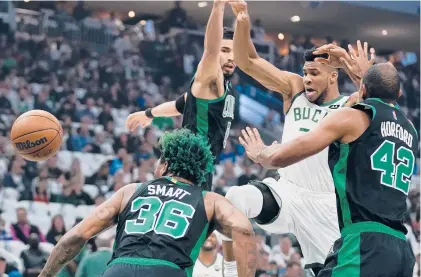  ?? MORRY GASH/AP ?? The Bucks’ Giannis Antetokoun­mpo loses the ball as he drives to the basket against the Celtics in Game 4 on Monday in Milwaukee.