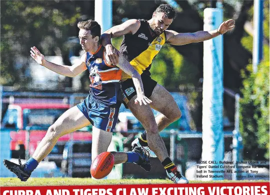  ?? Picture: ZAK SIMMONDS ?? CLOSE CALL: Bulldogs’ Joshua Ubank and Tigers’ Daniel Cuttiford compete for the ball in Townsville AFL action at Tony Ireland Stadium.