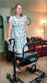  ?? ART GENTILE/BUCKS COUNTY COURIER TIMES VIA AP ?? In an Aug. 13, 2018 photo, Kristin Ognjanovac, of Allentown, who has been living with Parkinson’s disease for 10 years, has to use a walker at times during the day.
