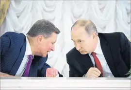  ?? Alexei Druzhinin Pool Photo ?? RUSSIAN President Vladimir Putin, right, shown at an economic forum in St. Petersburg, Russia, denies colluding with Donald Trump’s presidenti­al campaign.