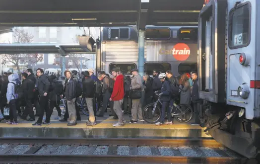  ?? Paul Chinn / The Chronicle ?? Crowds of commuters arrive at the Caltrain station on Fourth and King streets in San Francisco. Ridership on the commuter railroad is at an all-time high, and growing, with trains frequently filled beyond their capacity.