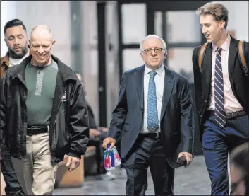  ?? Mary Altaffer The Associated Press ?? Eagles manager Irving Azoff, center, arrives at court Thursday in New York, for a criminal case involving ownership of the handwritte­n lyrics to“hotel California.”