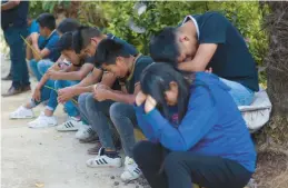  ?? YERANIA ROLON/AP ?? People pray for brothers Yovani and Jair Valencia Olivares and their cousin Misael Olivares Monterde on Thursday in the village of San Marcos Atexquilap­an, Mexico.