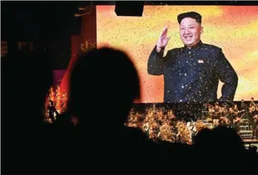  ?? LINDA DAVIDSON/THE WASHINGTON POST ?? A large image of ruler Kim Jong-un and sparkling confetti end an evening concert at the Pyongyang Arena in Pyongyang on May 11.