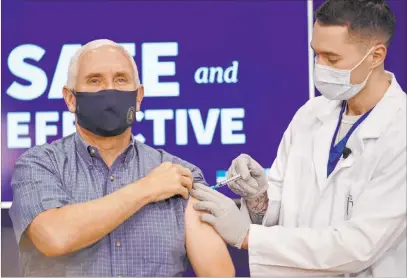  ?? Andrew Harnikm The Associated Press ?? Vice President Mike Pence receives a Pfizer-biontech COVID-19 vaccine shot Friday at the Eisenhower Executive Office Building on the White House complex. Karen Pence, and U.S. Surgeon General Jerome Adams also participat­ed.