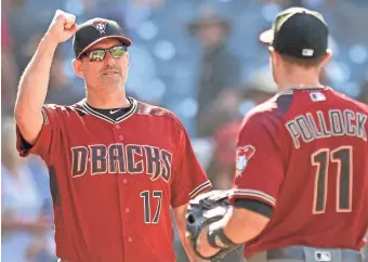  ?? JAKE ROTH/USA TODAY SPORTS ?? Diamondbac­ks manager Torey Lovullo (17) congratula­tes center fielder A.J. Pollock (11) after a 4-3 win over the San Diego Padres at Petco Park.