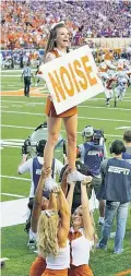  ??  ?? Kaitlyn Behnke tops a formation at a Texas Longhorns game during her college years.