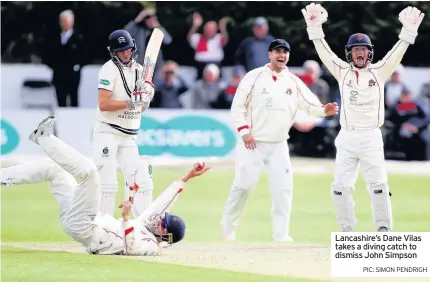  ??  ?? Lancashire’s Dane Vilas takes a diving catch to dismiss John Simpson