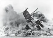  ?? Associated Press ?? SMOKE rises as the Arizona topples into the sea on Dec. 7, 1941, during Japan’s surprise attack on Hawaii.