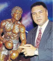  ?? /Reuters ?? Muhammad Ali with a sculpture of himself after it was unveiled in Las Vegas on April 21 1995.
The Greatest: