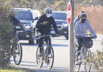  ?? Joe Raedle / Getty Images ?? President-elect Joe Biden and his wife, Jill Biden, go for a bike ride on Saturday through Cape Henlopen State Park in Lewes, Del. The Bidens have been staying at a vacation home in Rehoboth Beach while the president-elect is working on his transition.