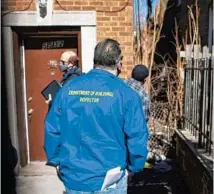  ??  ?? Department of Buildings Commission­er Matthew Beaudet joins a team inspecting a residentia­l property with code violations March 3 in the Austin neighborho­od.