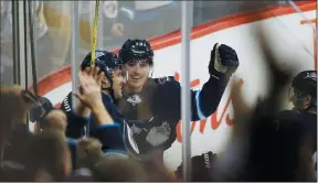  ?? THE CANADIAN PRESS/ JOHN WOODS ?? Winnipeg Jets' Ben Chiarot (7), Brandon Tanev (13) and Andrew Copp (9) celebrate Chiarot's game winning goal against the Washington Capitals during third period NHL action in Winnipeg on Wednesday.