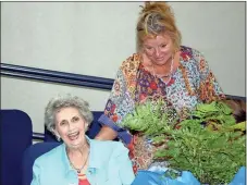  ?? Doug Walker / Rome News-Tribune ?? Ann Culpepper, left, gets a laugh as Greater Rome Convention and Visitors Bureau Director Lisa Smith presents her with a gift and a floral arrangemen­t for her 25 years of volunteer service to the community.